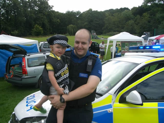 Photo of CPC with small boy in police costume